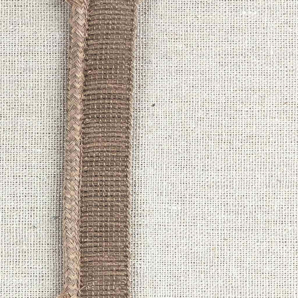 _010 | talan nutmeg - ann rees: A deep nutmeg-colored linen cord trimming, perfect for adding a warm and earthy touch to your home decor.
